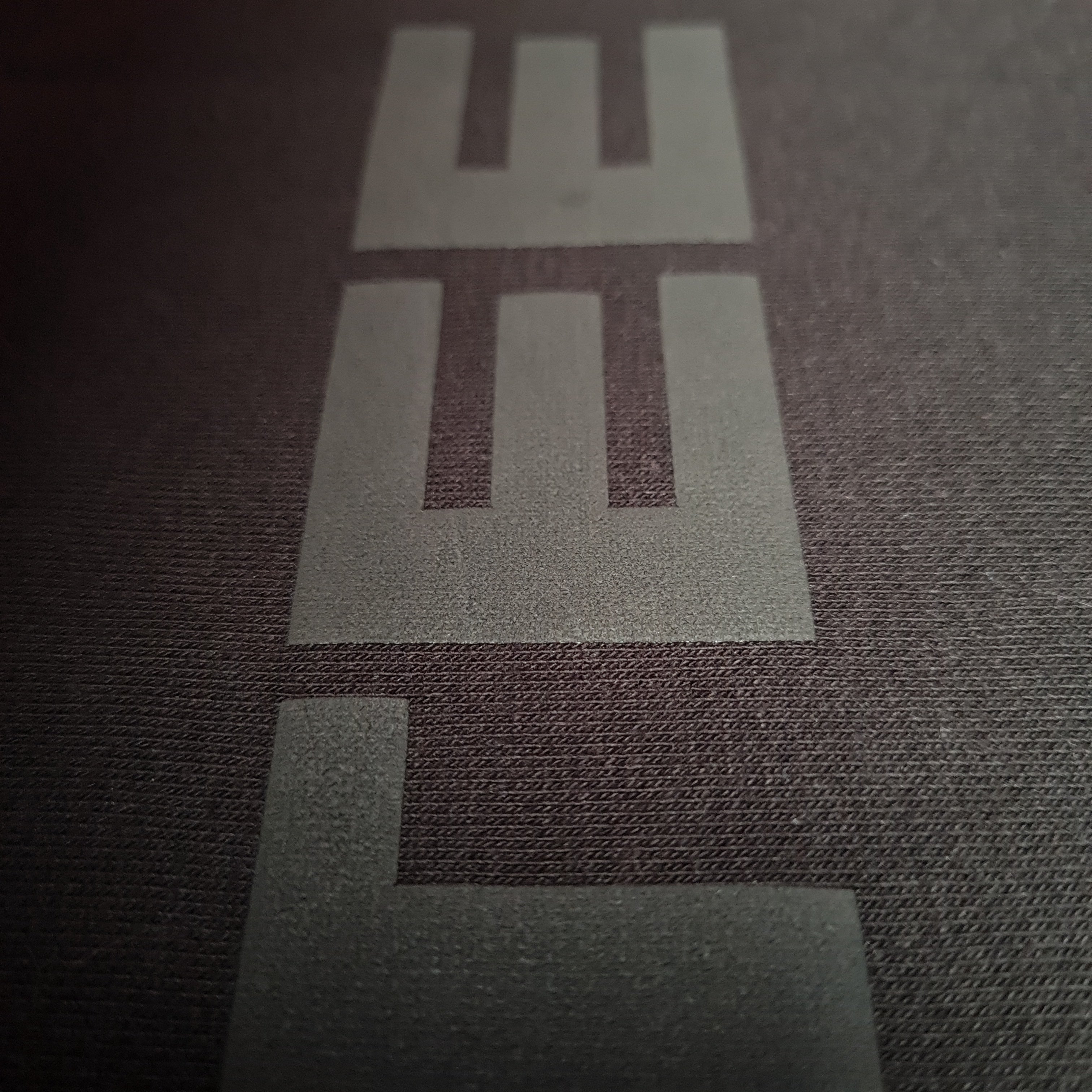 Close-up of a logo on a textured surface