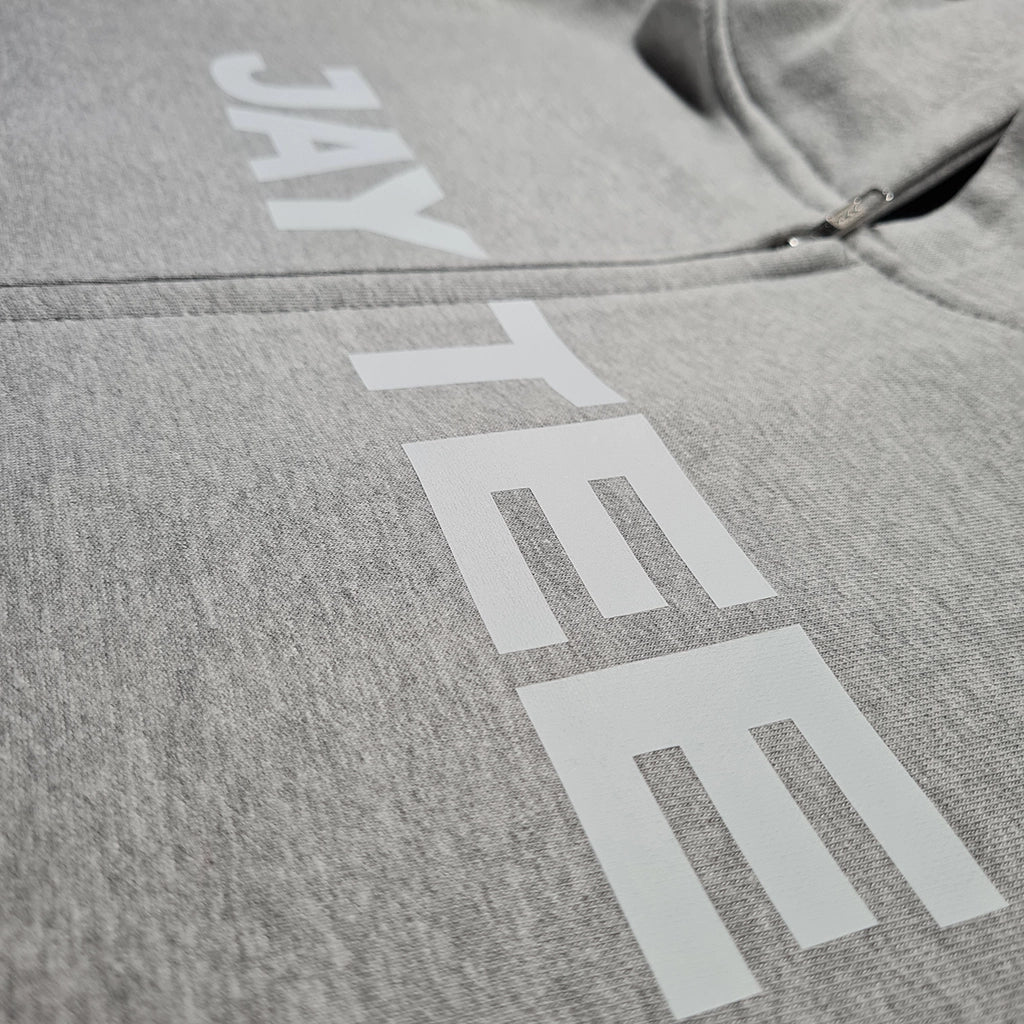 Gray hoodie with 'JAYTEE' branding on a plain background