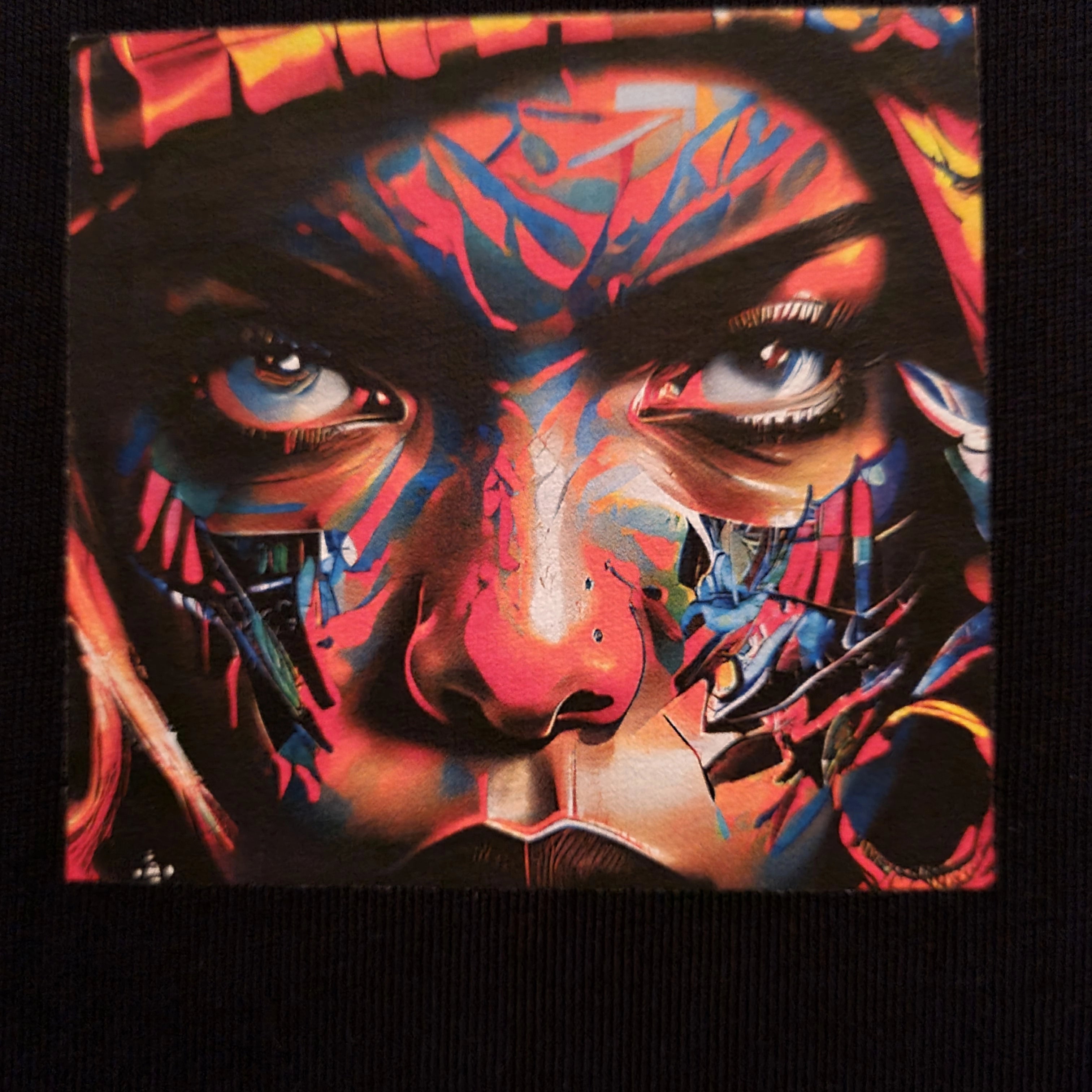 Colorful abstract art of a face with intense expression on a black background