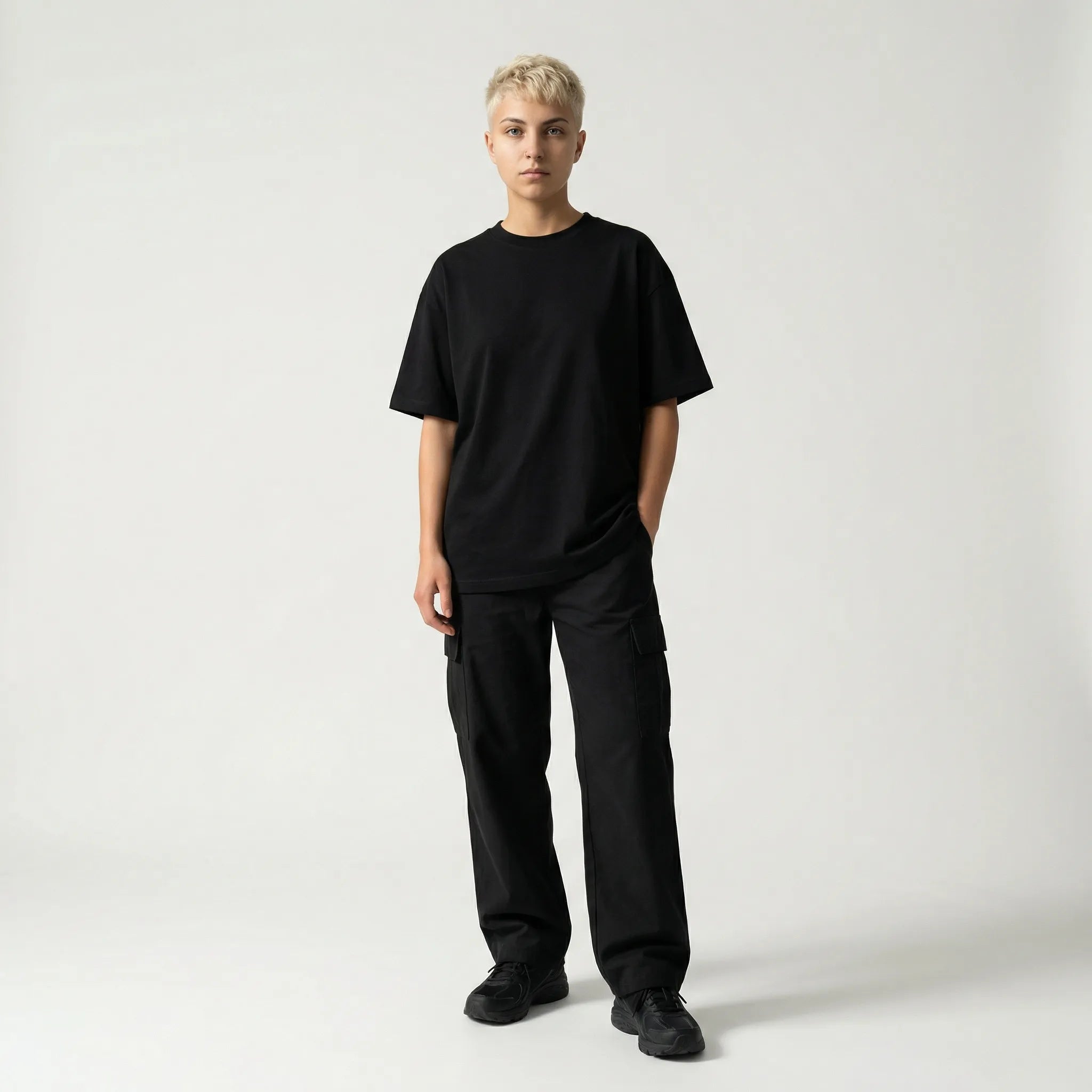 Person wearing a black JAYTEE outfit on a white background