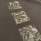 Black t-shirt with abstract design and text on a dark background