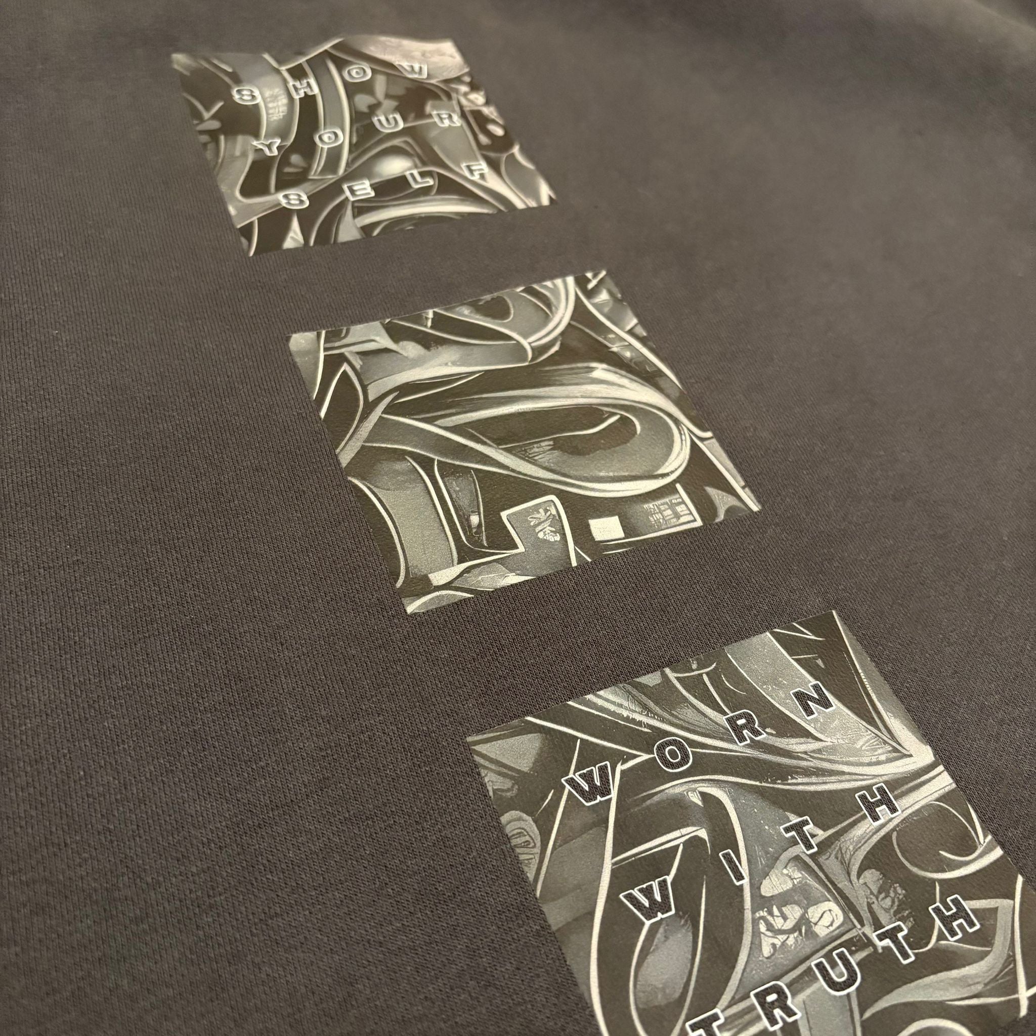 Black t-shirt with abstract design and text on a dark background