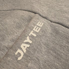 Gray fabric with 'JAYTEE' logo embroidered on it