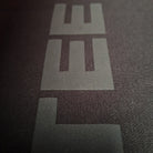 Close-up of a logo on a textured surface