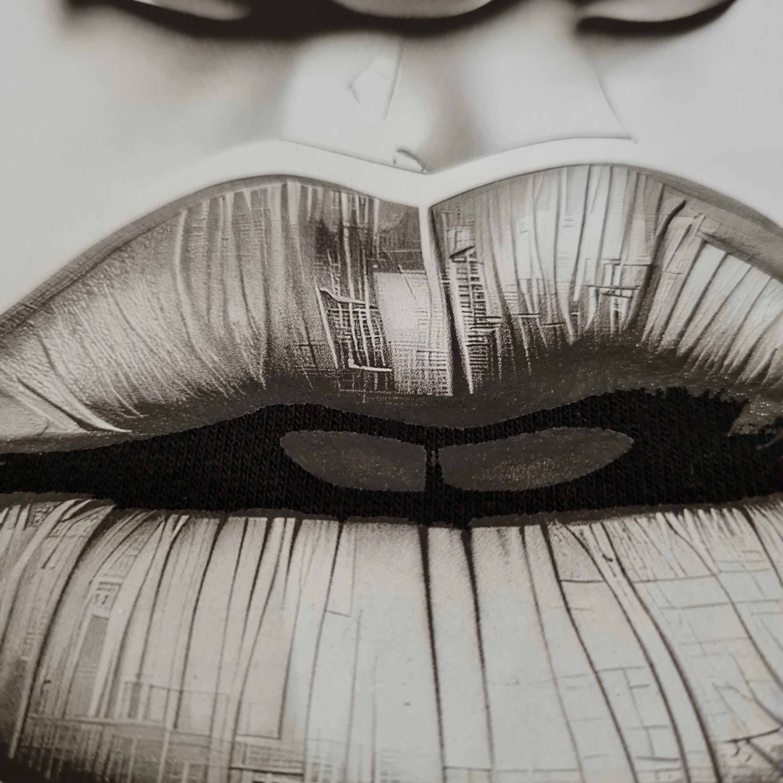 Close-up of a person's eyes with a cityscape reflection.