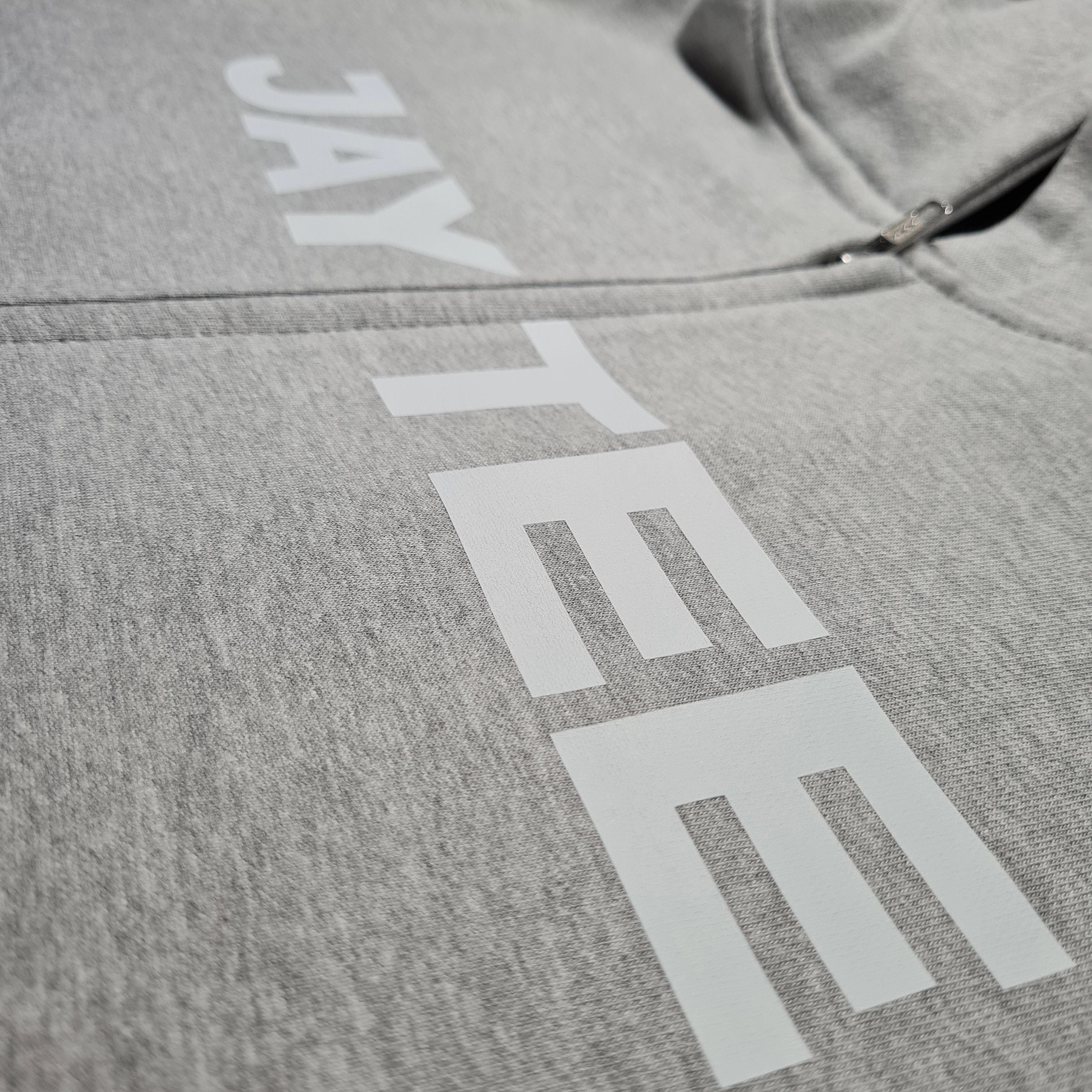 Gray hoodie with 'JAY TEE' branding on a close-up view