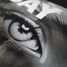 Close-up of a stylized eye with a star and text in the background