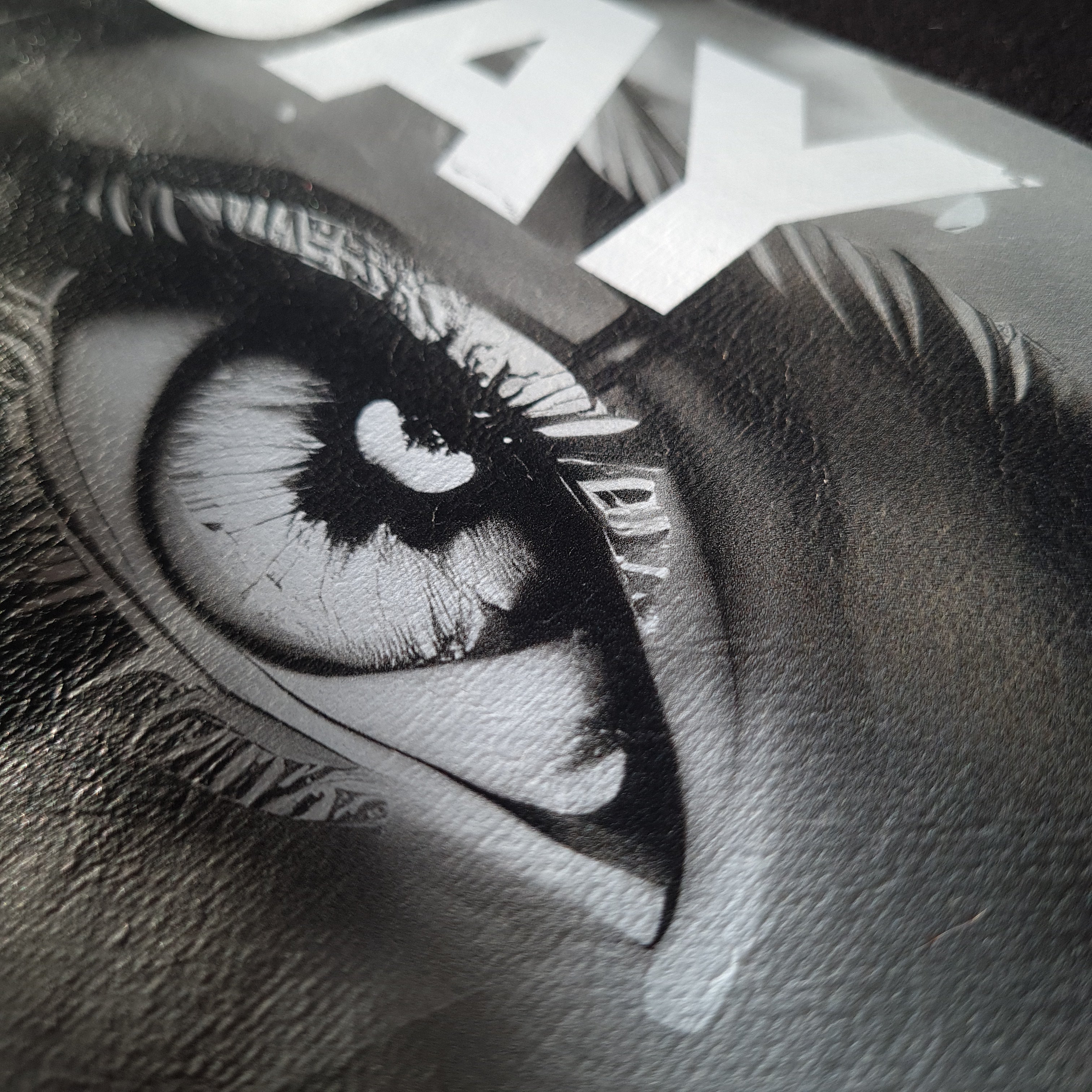 Close-up of a stylized eye with a star and text in the background