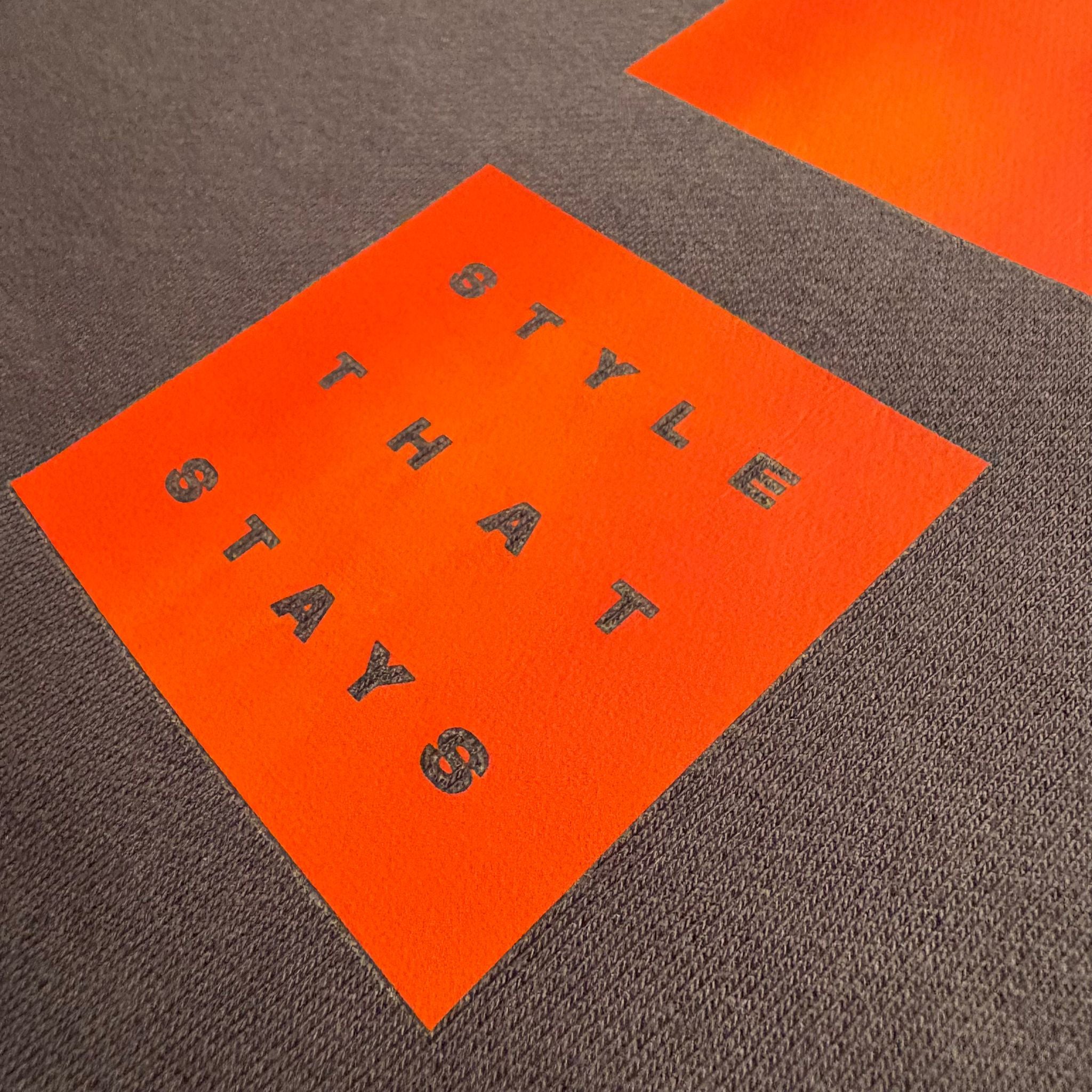 Orange square with black text on a brown surface