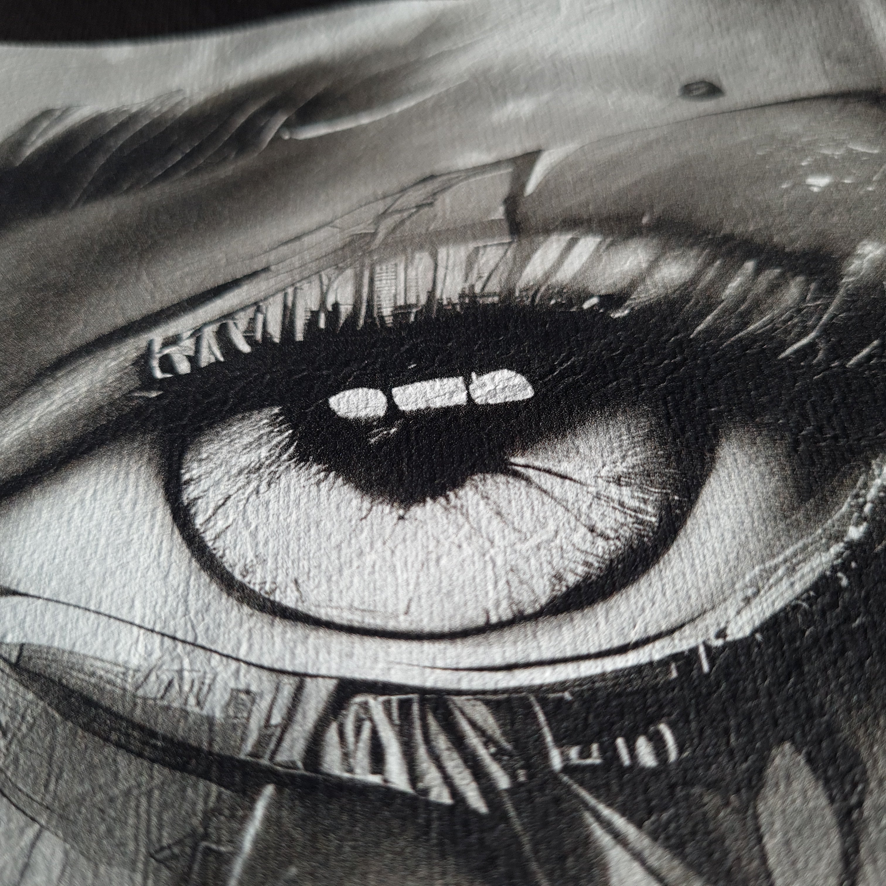 Close-up of a detailed black and white drawing of an eye