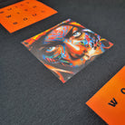 Colorful lion head design on a textured surface with orange text in the background