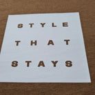White paper with 'STYLE THAT STAYS' text on a brown textured background