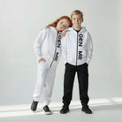 Two children wearing matching 'GEN ME' branded outfits on a plain background