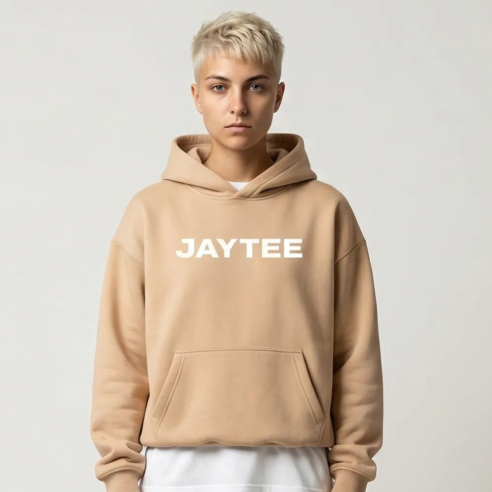 Person wearing a sand JAYTEE hoodie  logo on a white background