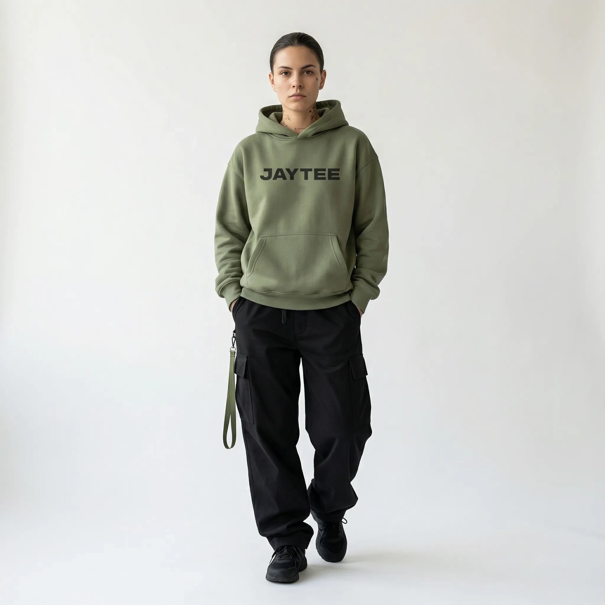 Person wearing a green hoodie with JAYTEE branding on a white background