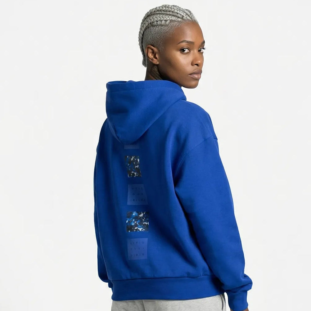 Person wearing a blue JAYTEE  hoodie and gray pants on a white background