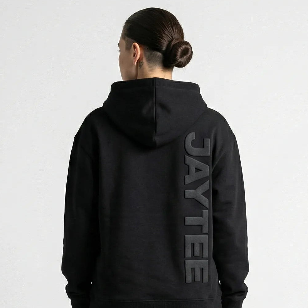 Person wearing a black hoodie with 'AYTEE branding on the back, standing against a white background.