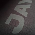Close-up of a textured surface with  JAYTEE branding.
