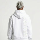 Person wearing a white JAYTEE hoodie with a brand logo on the back, standing against a plain background.