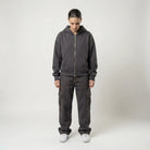 Person wearing a dark gray JAYTEE hoodie and cargo pants on a white background