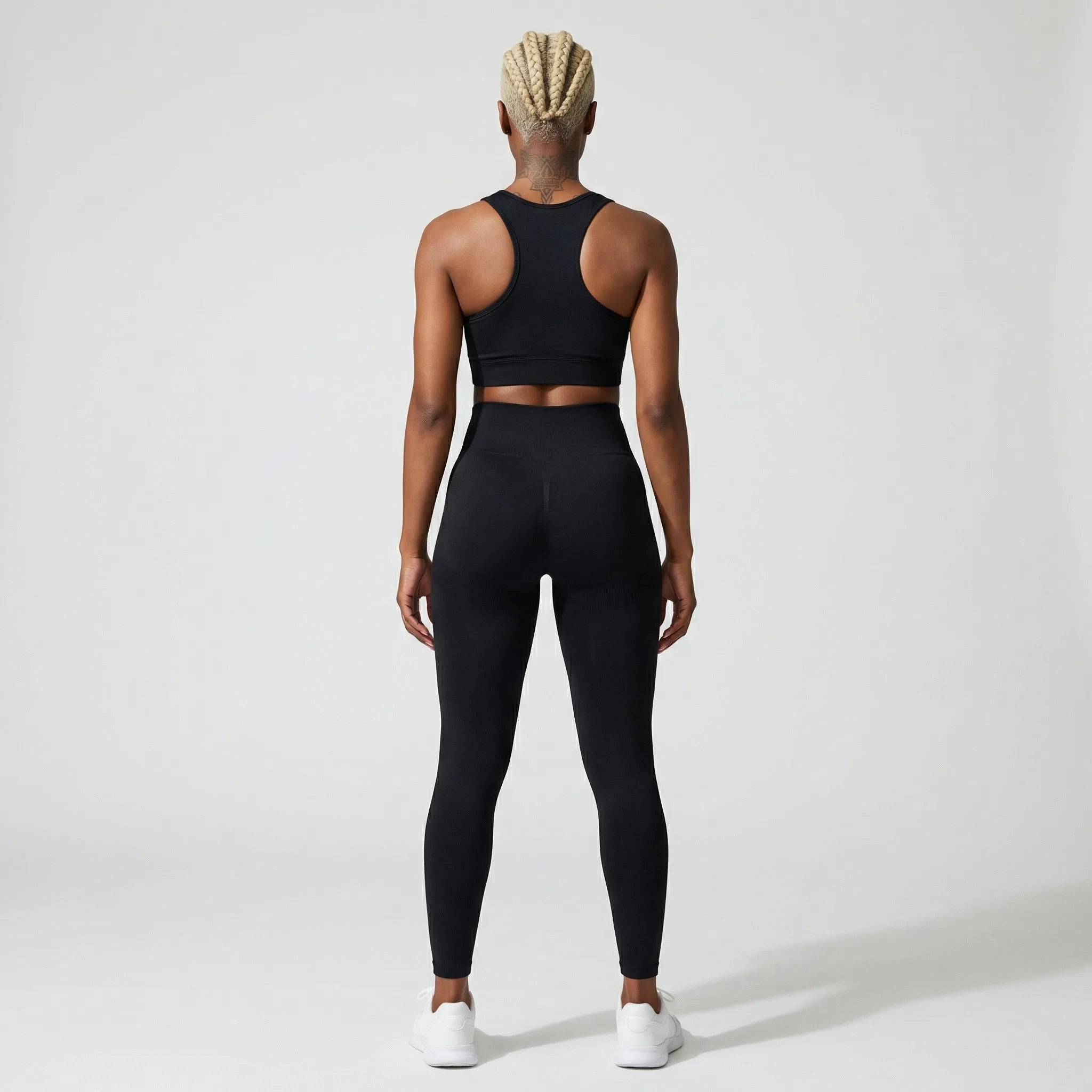 Person wearing a black athletic  JAYTEE outfit on a white background