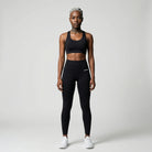 Person wearing a black athletic  JAYTEE outfit on a white background