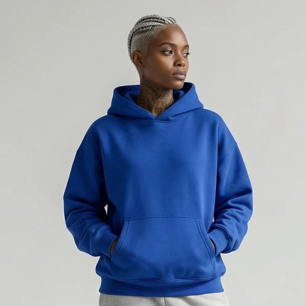 Person wearing a blue JAYTEE hoodie and gray sweatpants on a white background