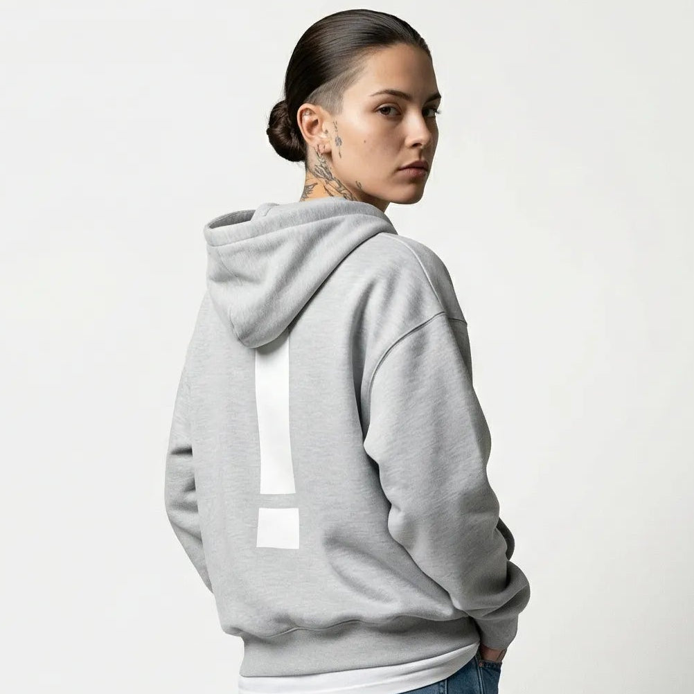 Person wearing a gray JAYTEE hoodie and blue jeans on a white background