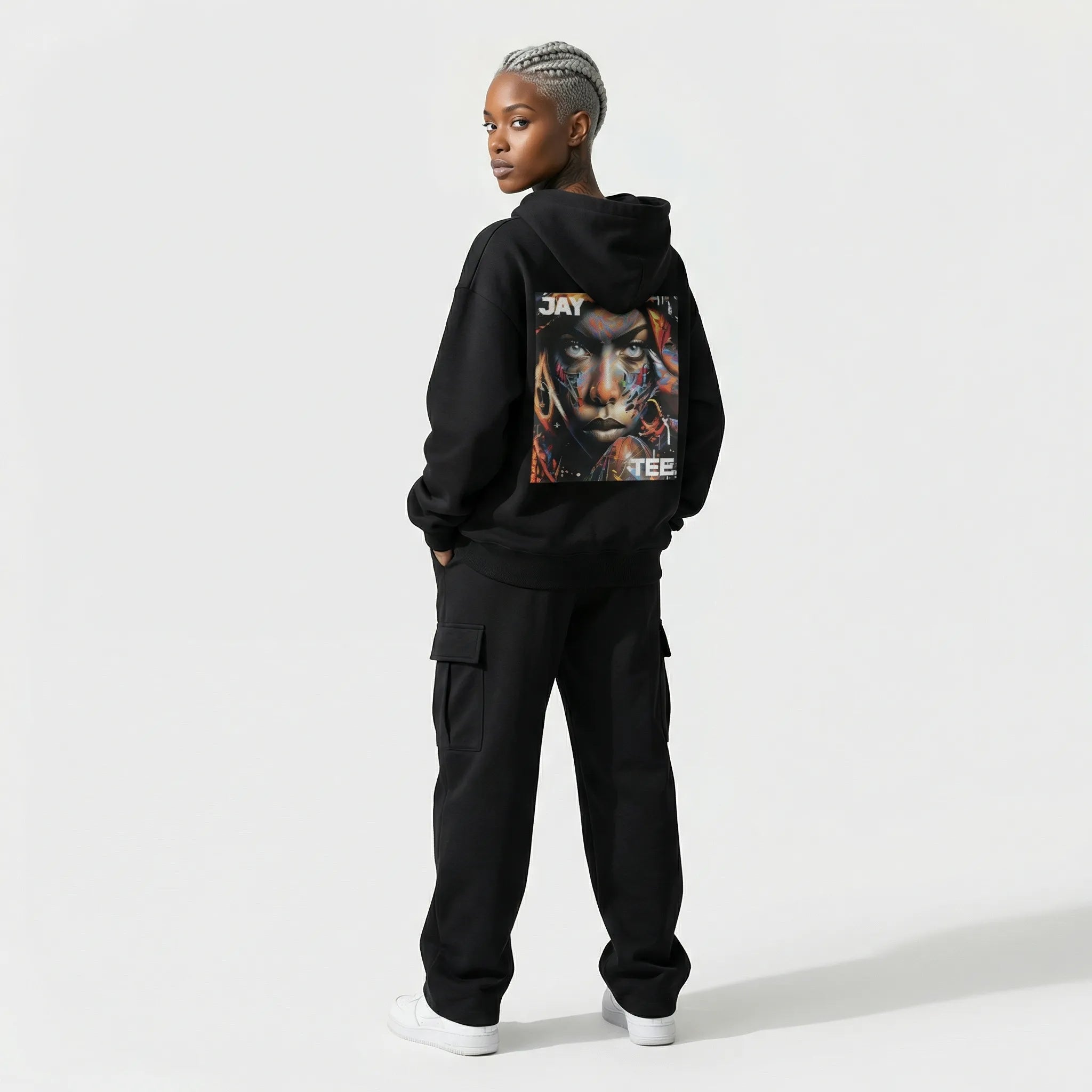 Person wearing a black JAYTEE hoodie with a graphic design on the back against a white background