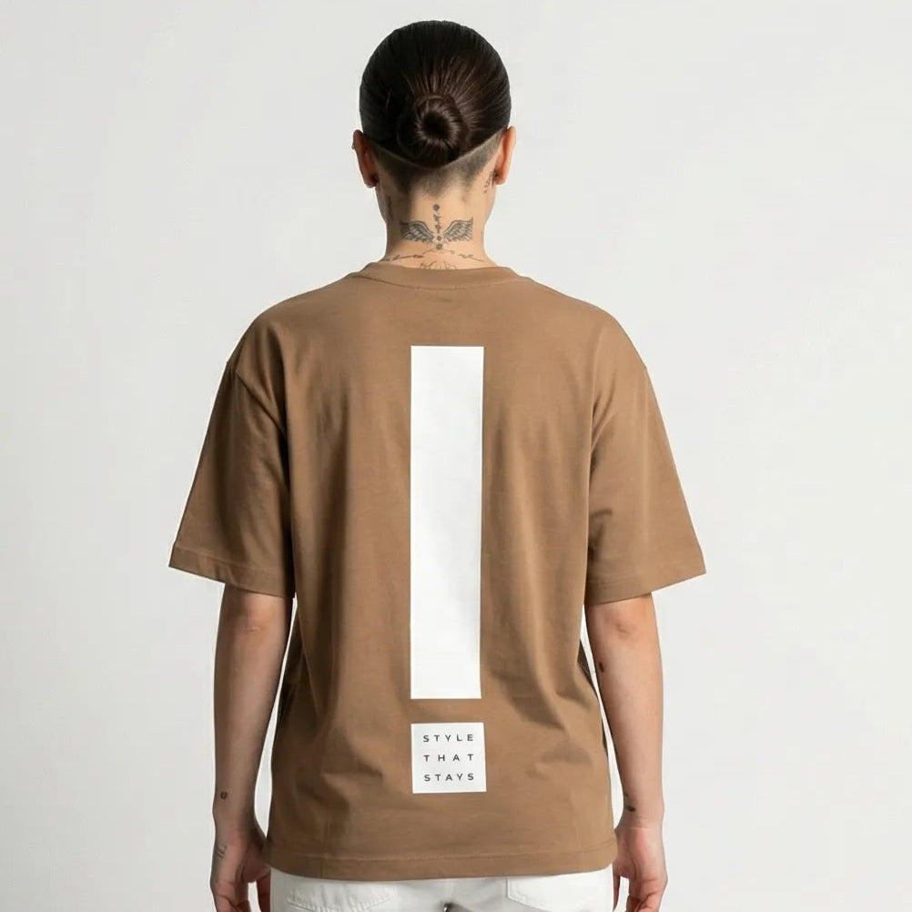 Person wearing a toffee JAYTEE t-shirt with a white logo on a plain background