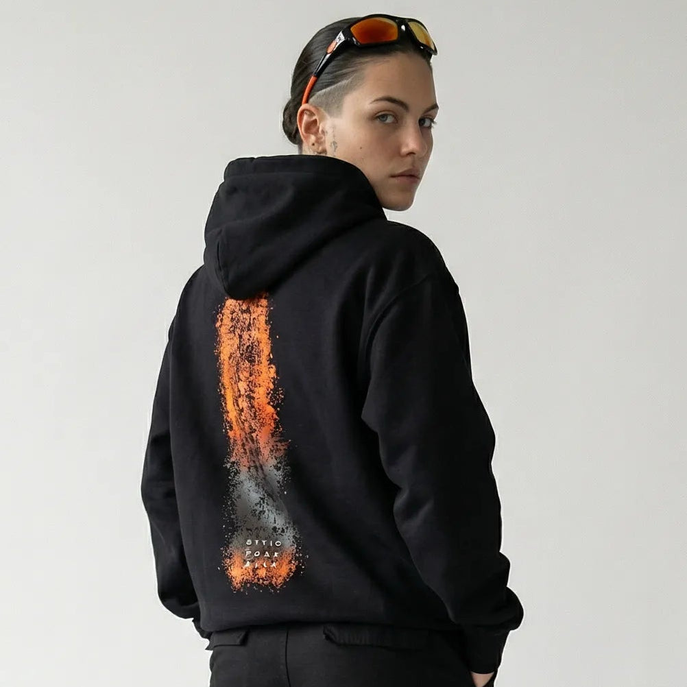 Person wearing a black JAYTEE hoodie with a unique design on the back against a white background