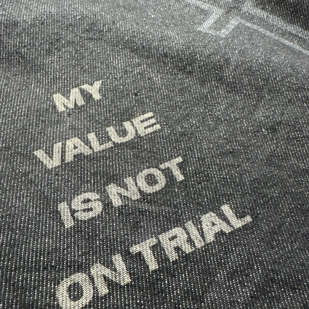 Text on a textured surface reading 'MY VALUE IS NOT ON TRIAL'.