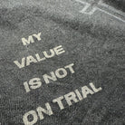 Text on a textured surface reading 'MY VALUE IS NOT ON TRIAL'.