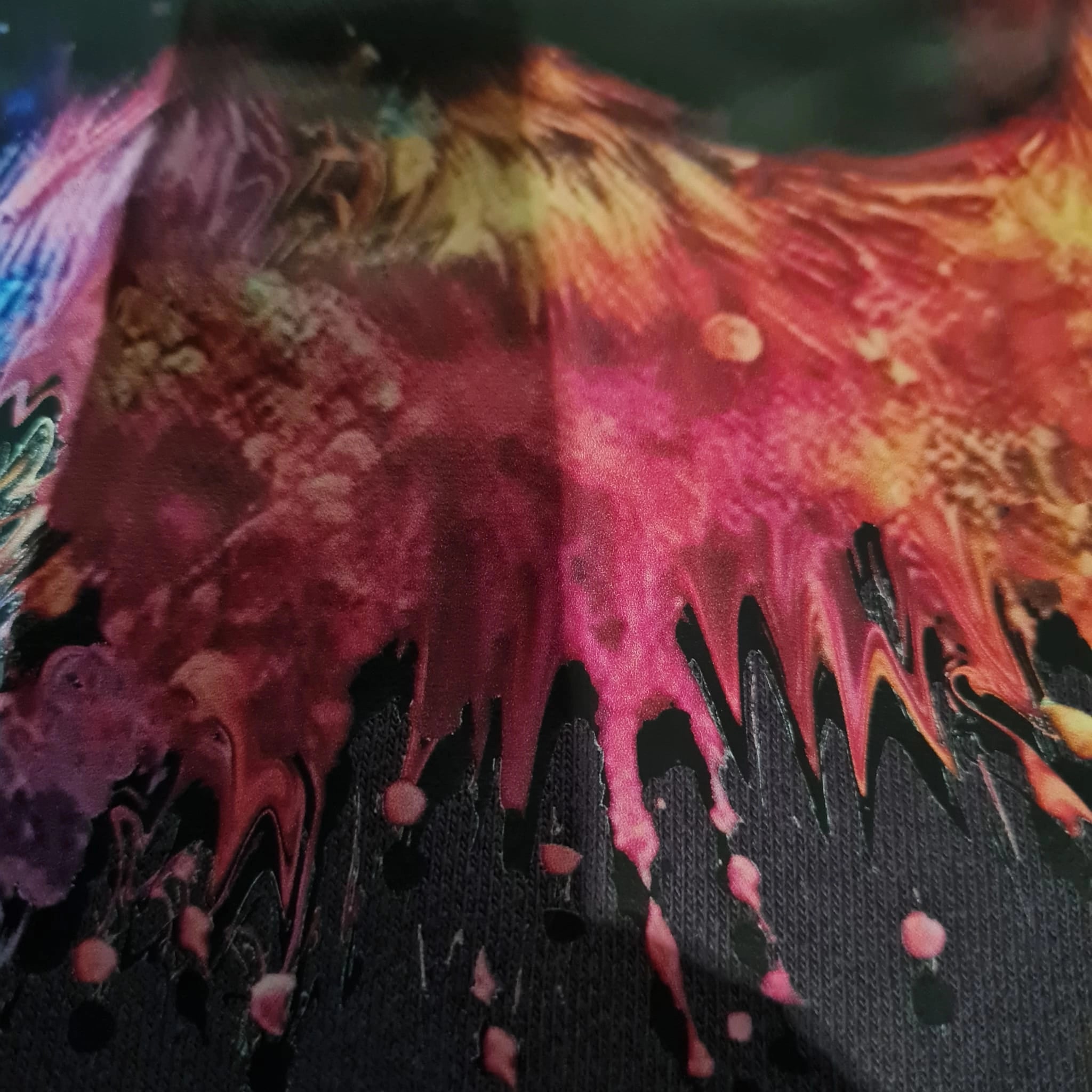 Colorful abstract painting with vibrant pink, red, and black on a dark background