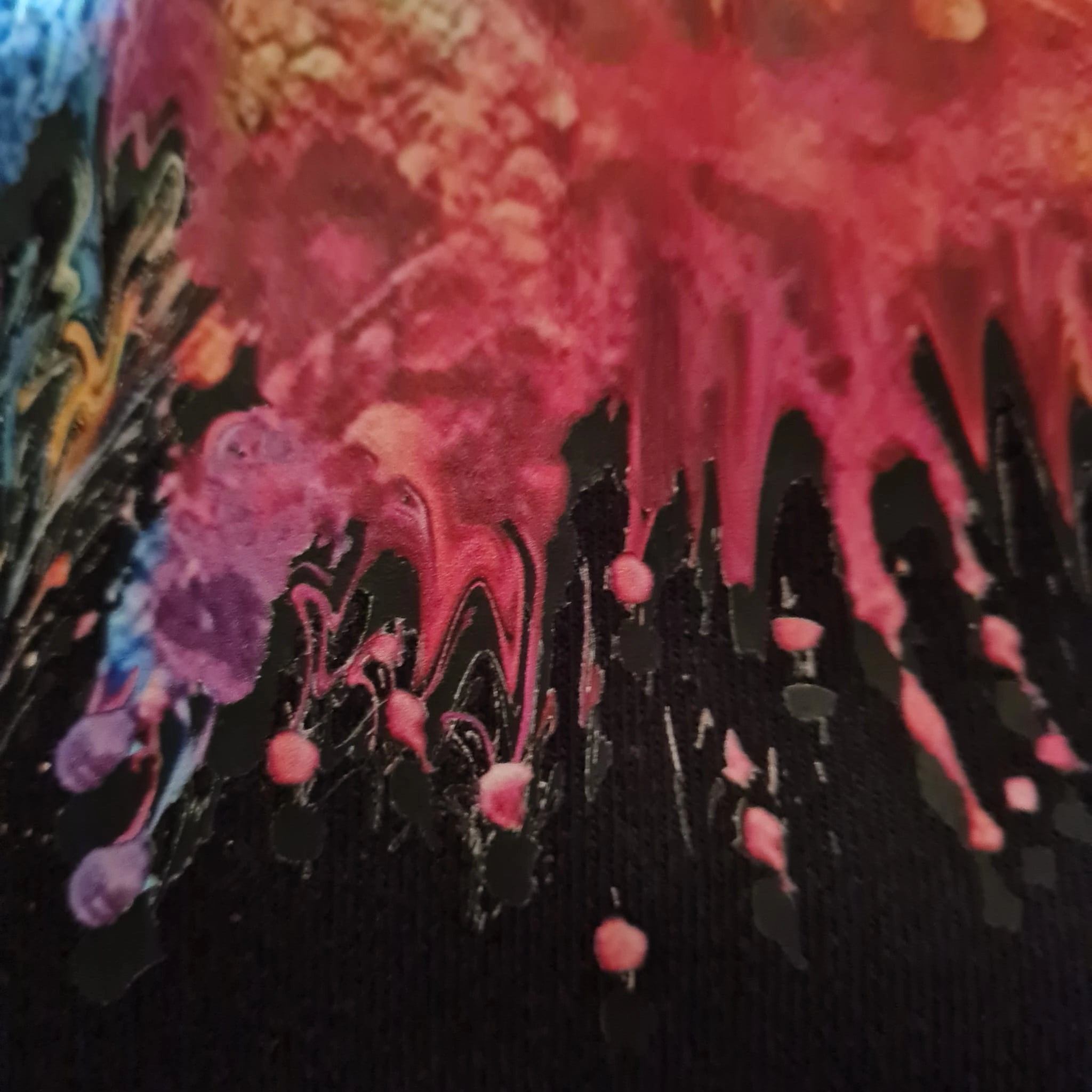 Colorful abstract art with dripping paint on a black background