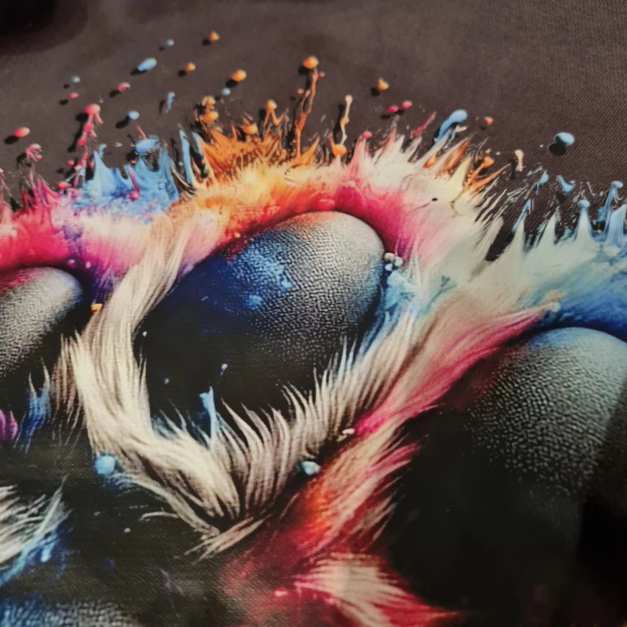 Colorful abstract design with feathers and splashes on a dark background